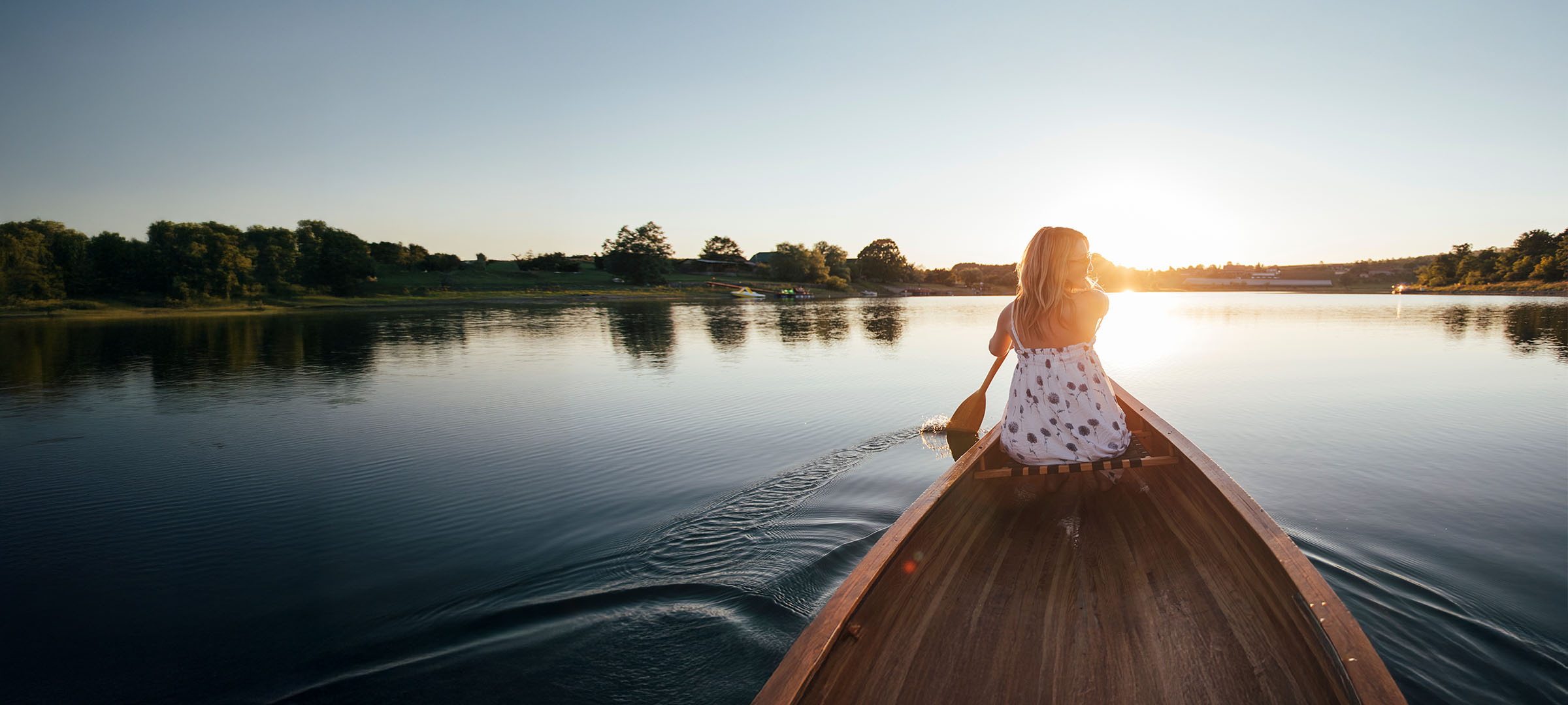 Woman on a boat enjoying Colorado scenery and lifestyle with Westerra Credit Union.