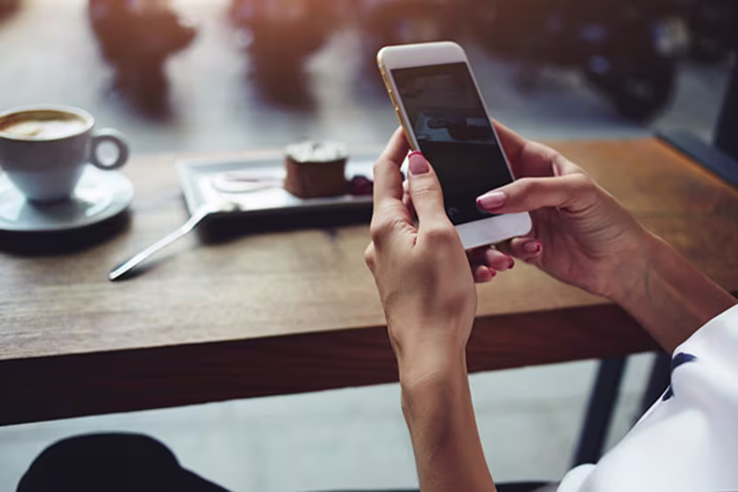 Lady with pink nails holding a phone