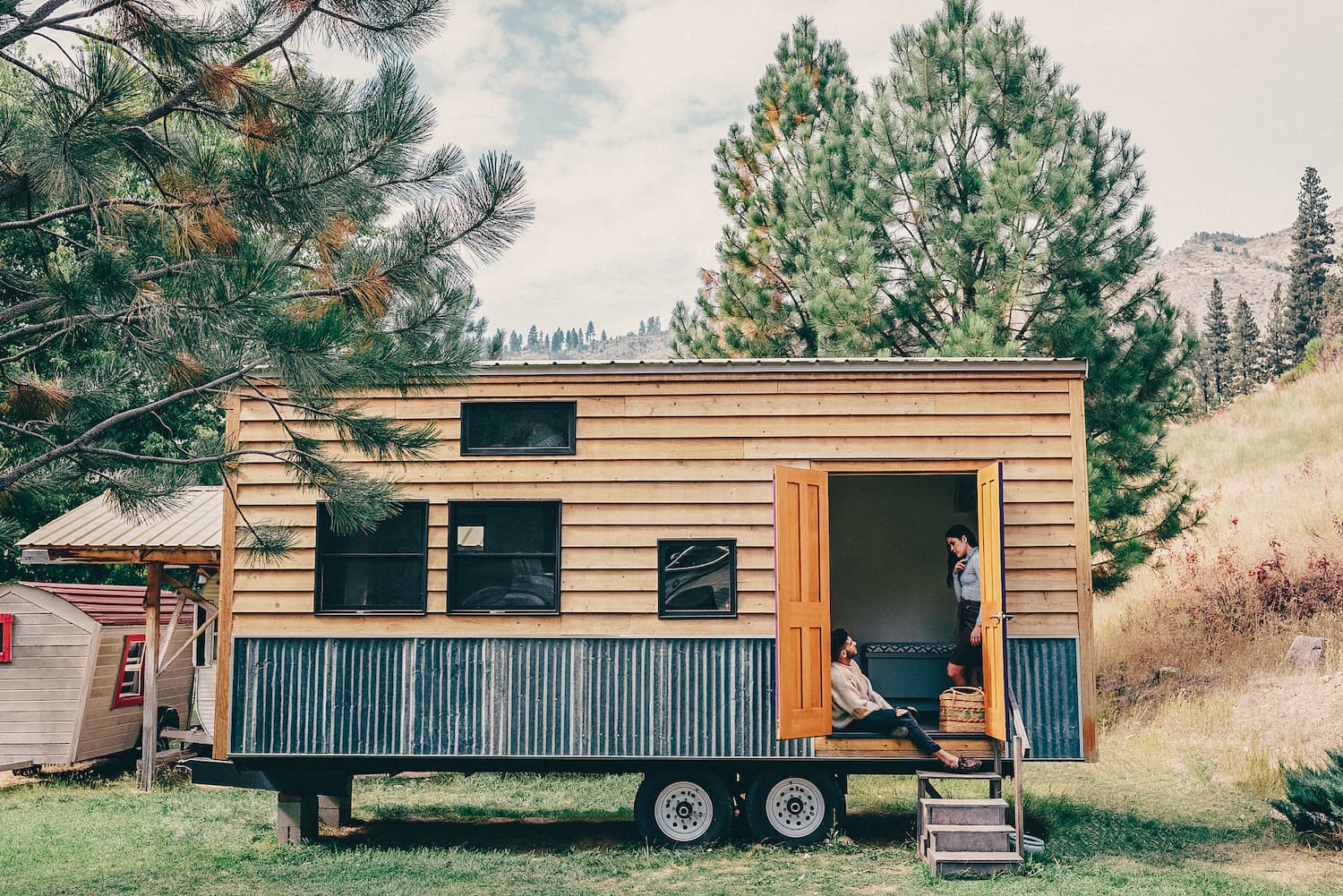 Man and woman sitting in a tiny house.