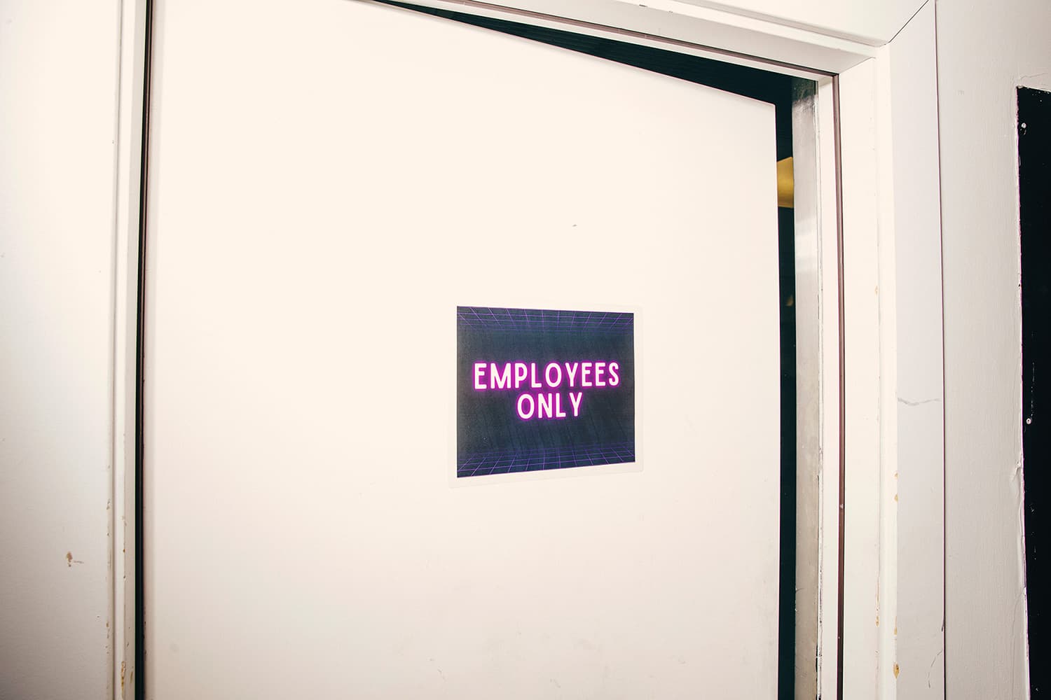 White door with Employees Only sign on it
