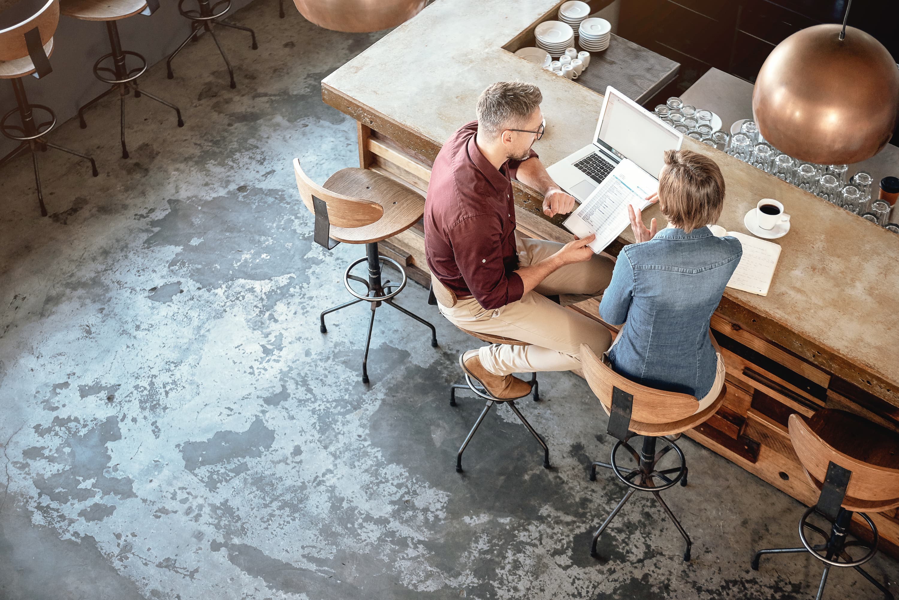 View from above of man and woman looking at paperwork