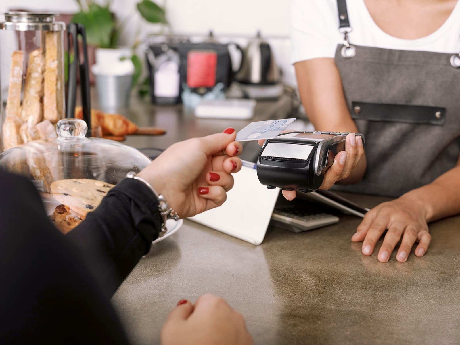 Woman holding her credit card to a card reader