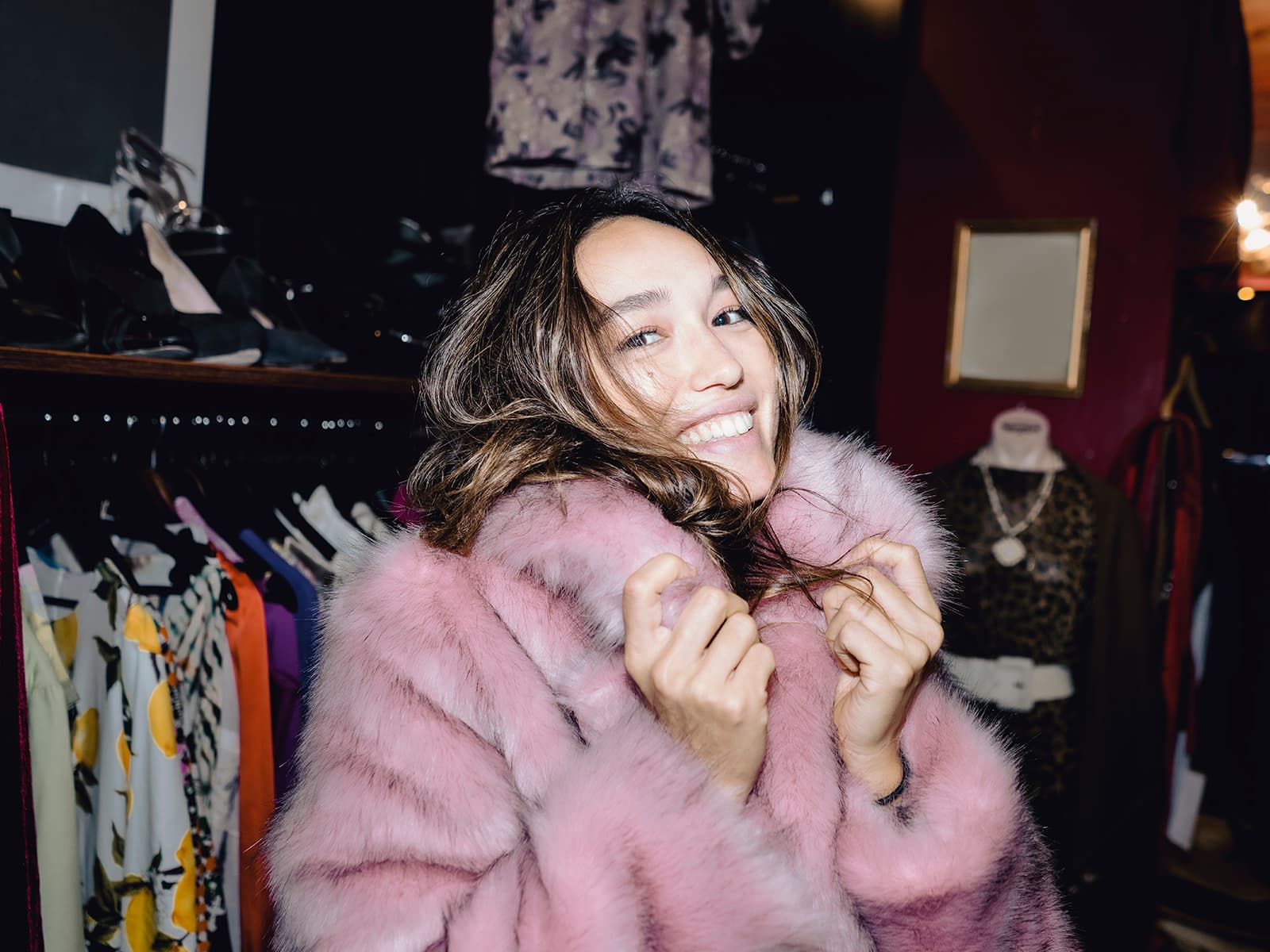 Woman in pink furry coat, smiling