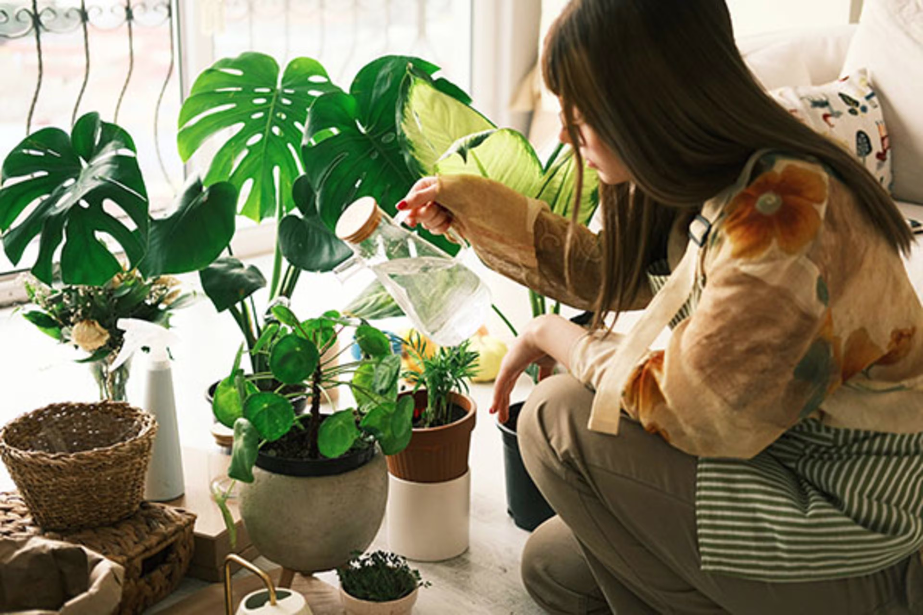 Woman caring for a monstera plant at home, with overlay text 'Specialty Mortgage Solutions'—Westerra offers tailored home loan options to fit unique needs across Colorado.
