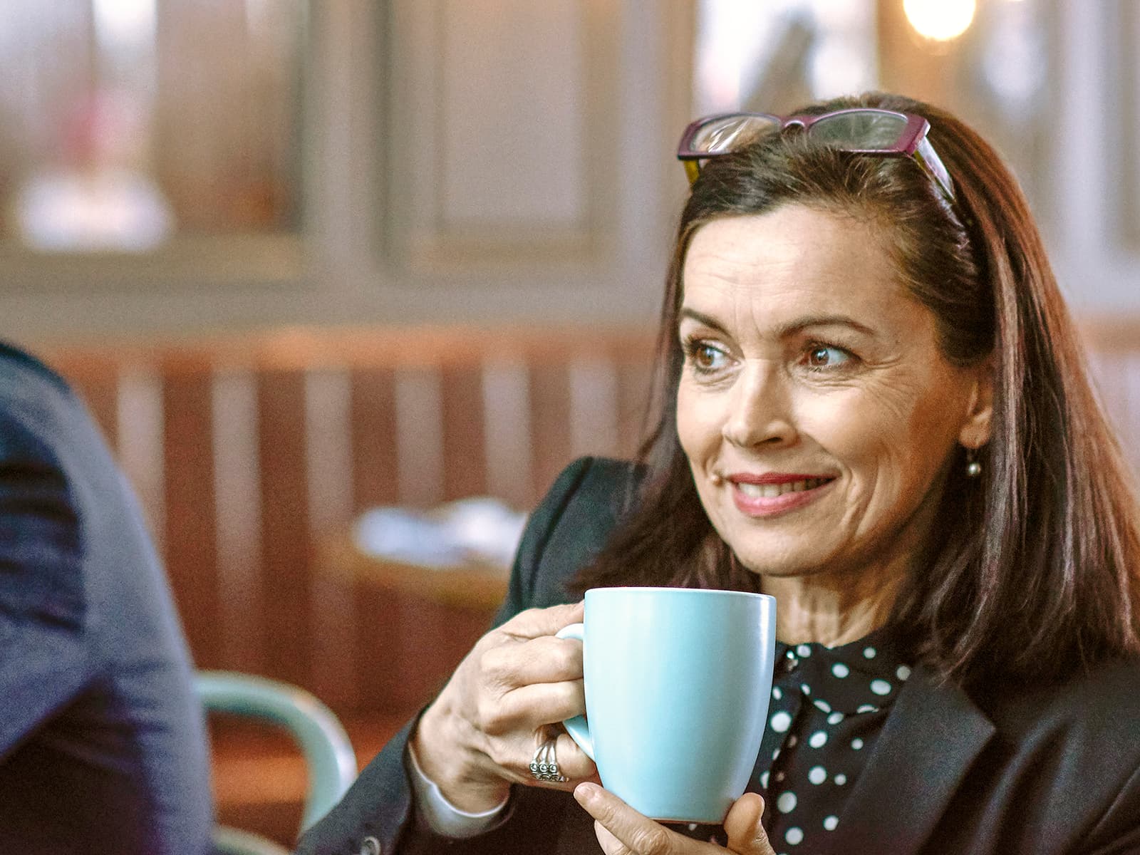 Woman drinking out of a mug