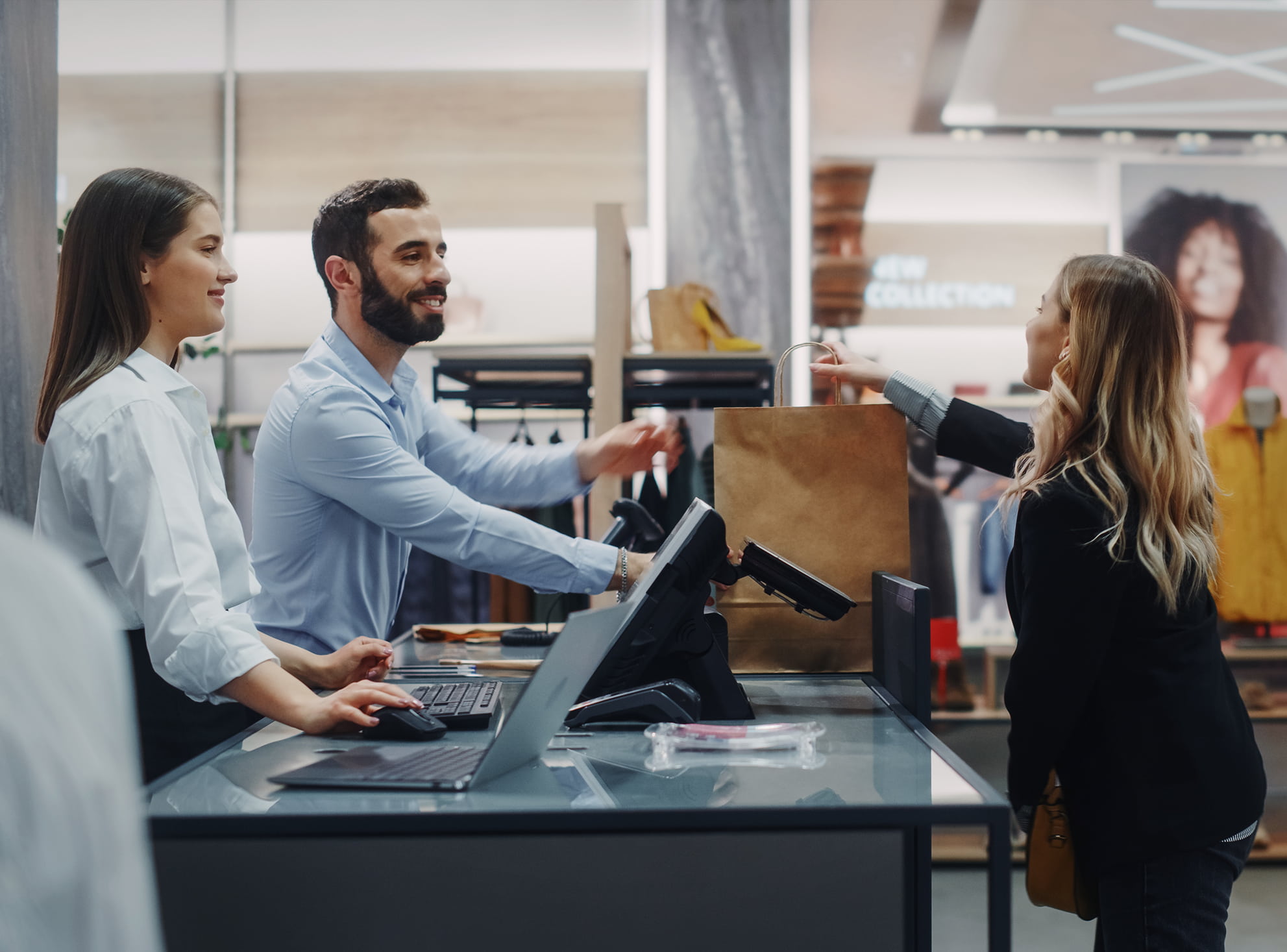 Woman making a purchase from salespeople.