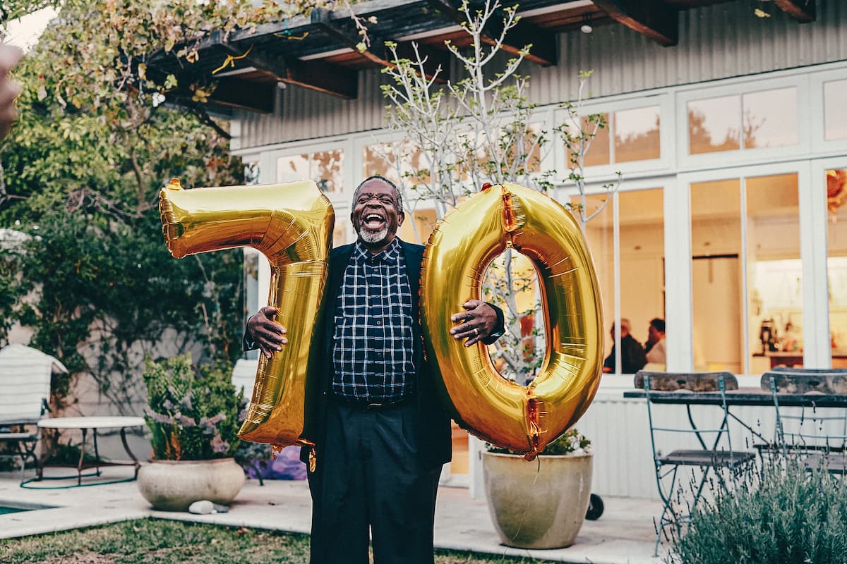 Man celebrates 70th birthday with balloons. 