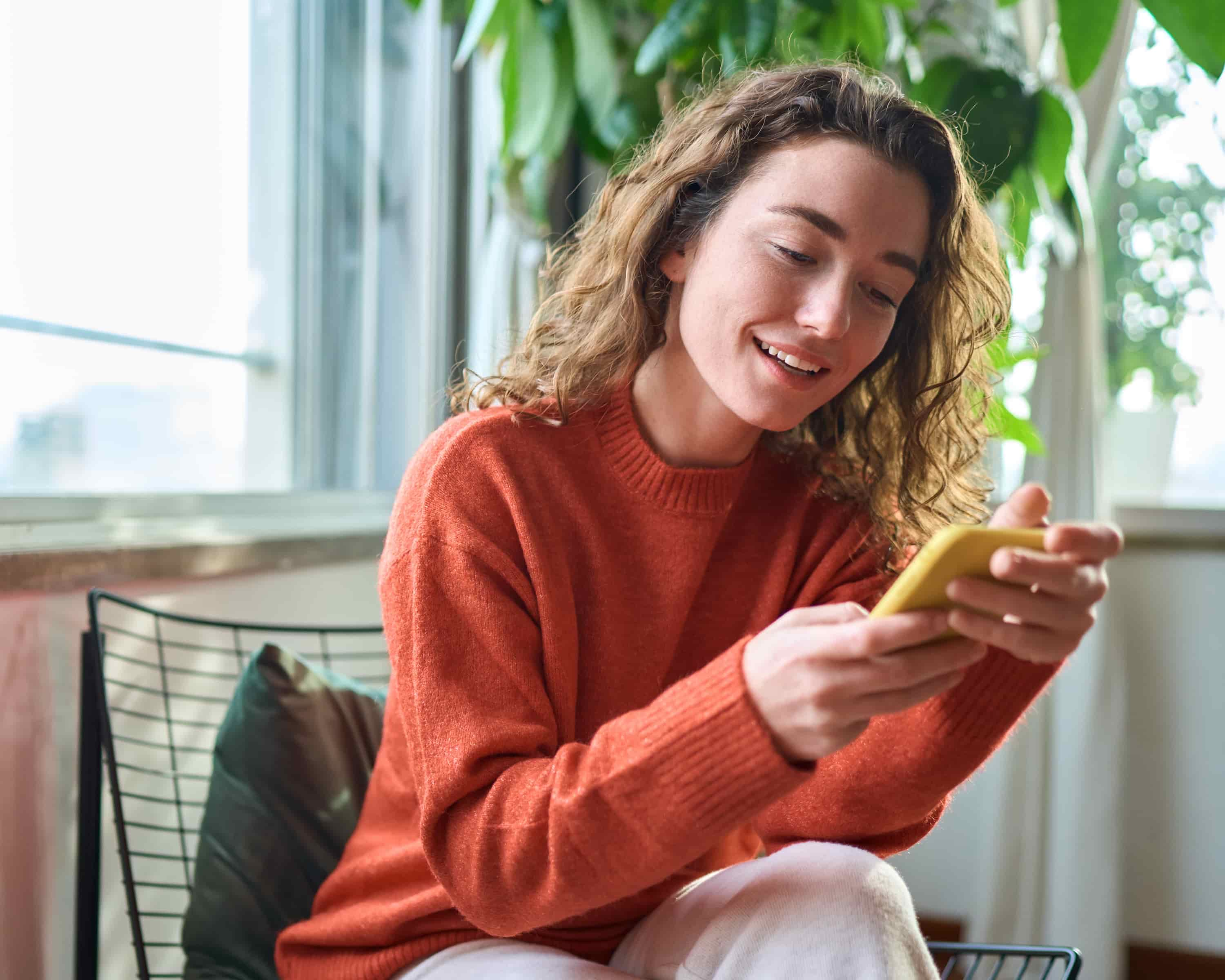 Woman looking at her phone and smiling