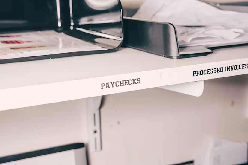 Shelf labelled "Paychecks" and "Processed Invoices"