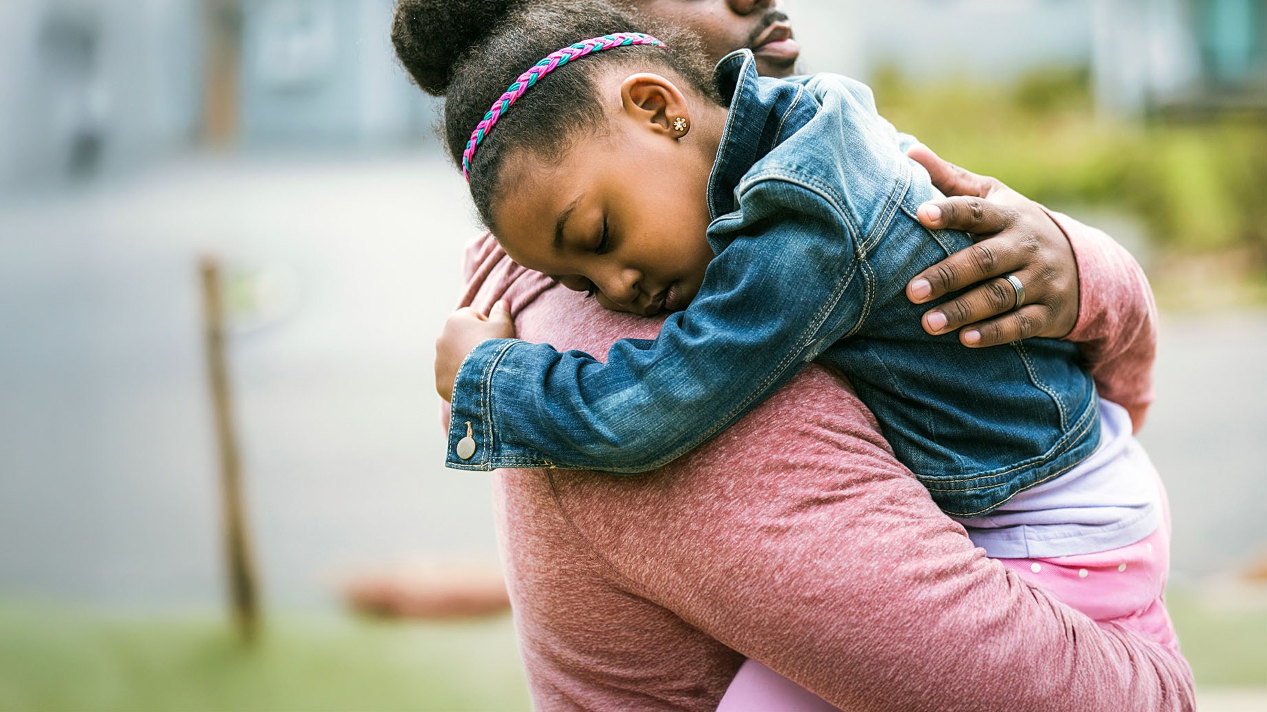 Happy father hugging daughter, representing the security and joy of building family savings with a trusted credit union.