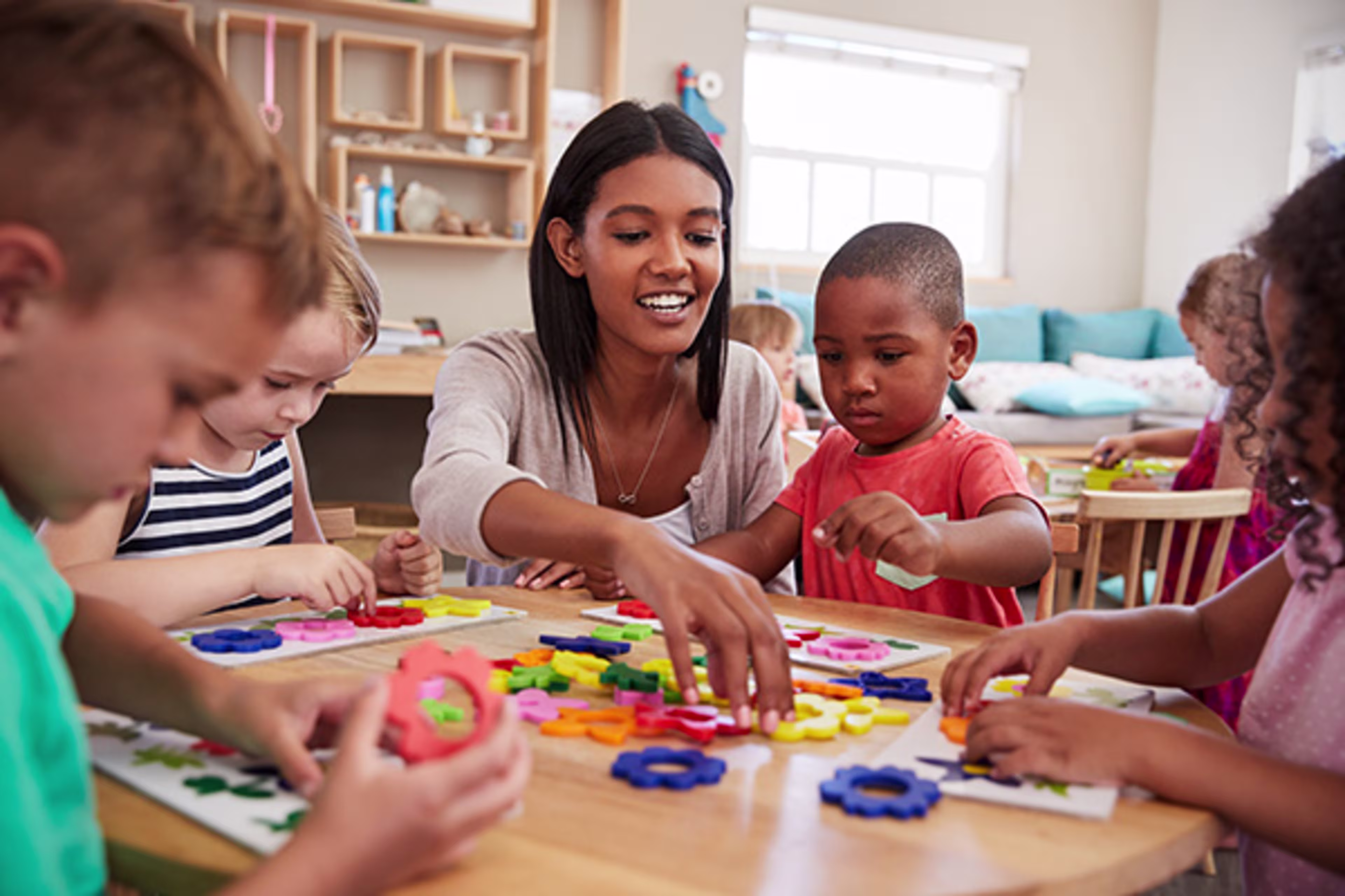 Teacher with children in a classroom.