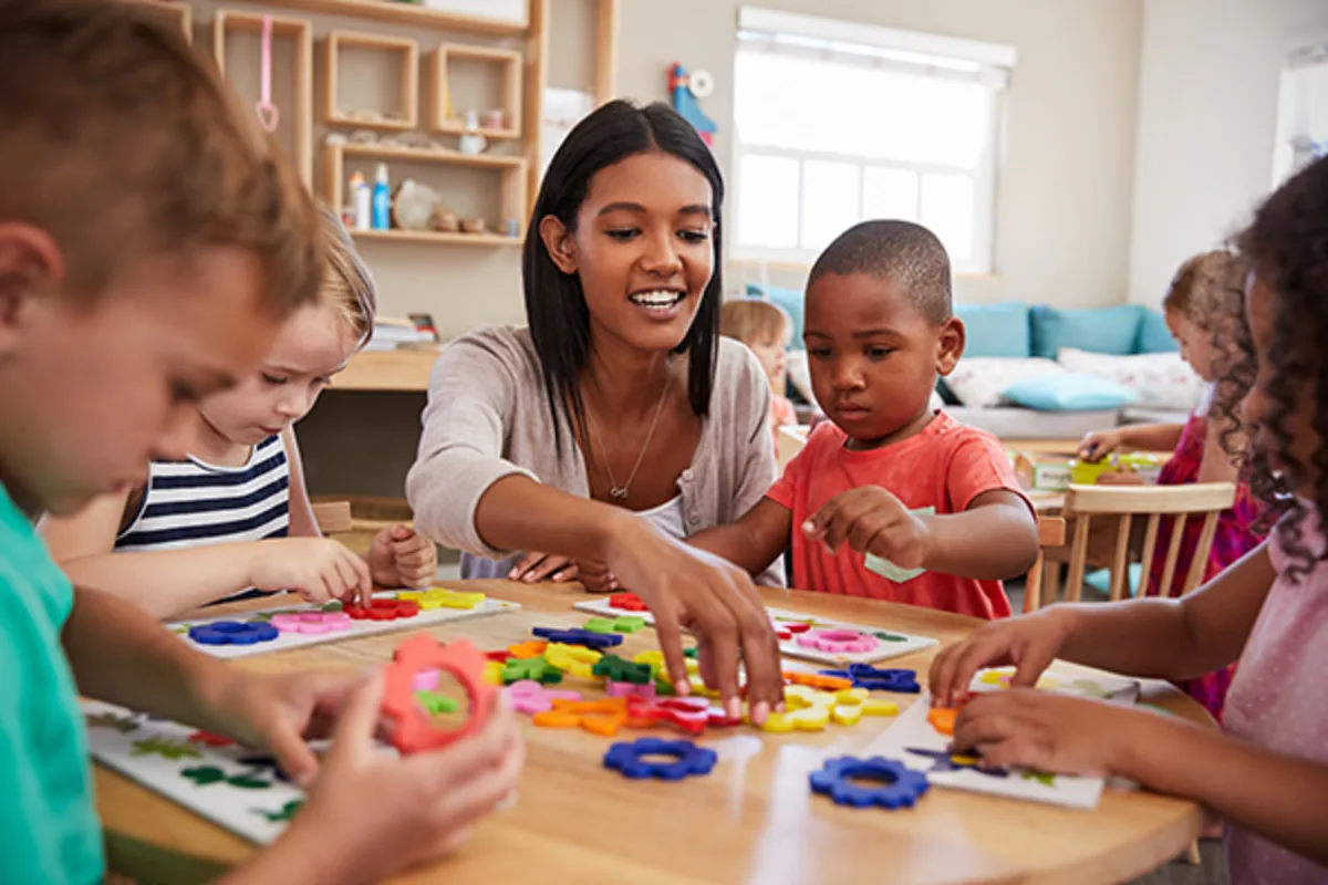Teacher with children in a classroom.