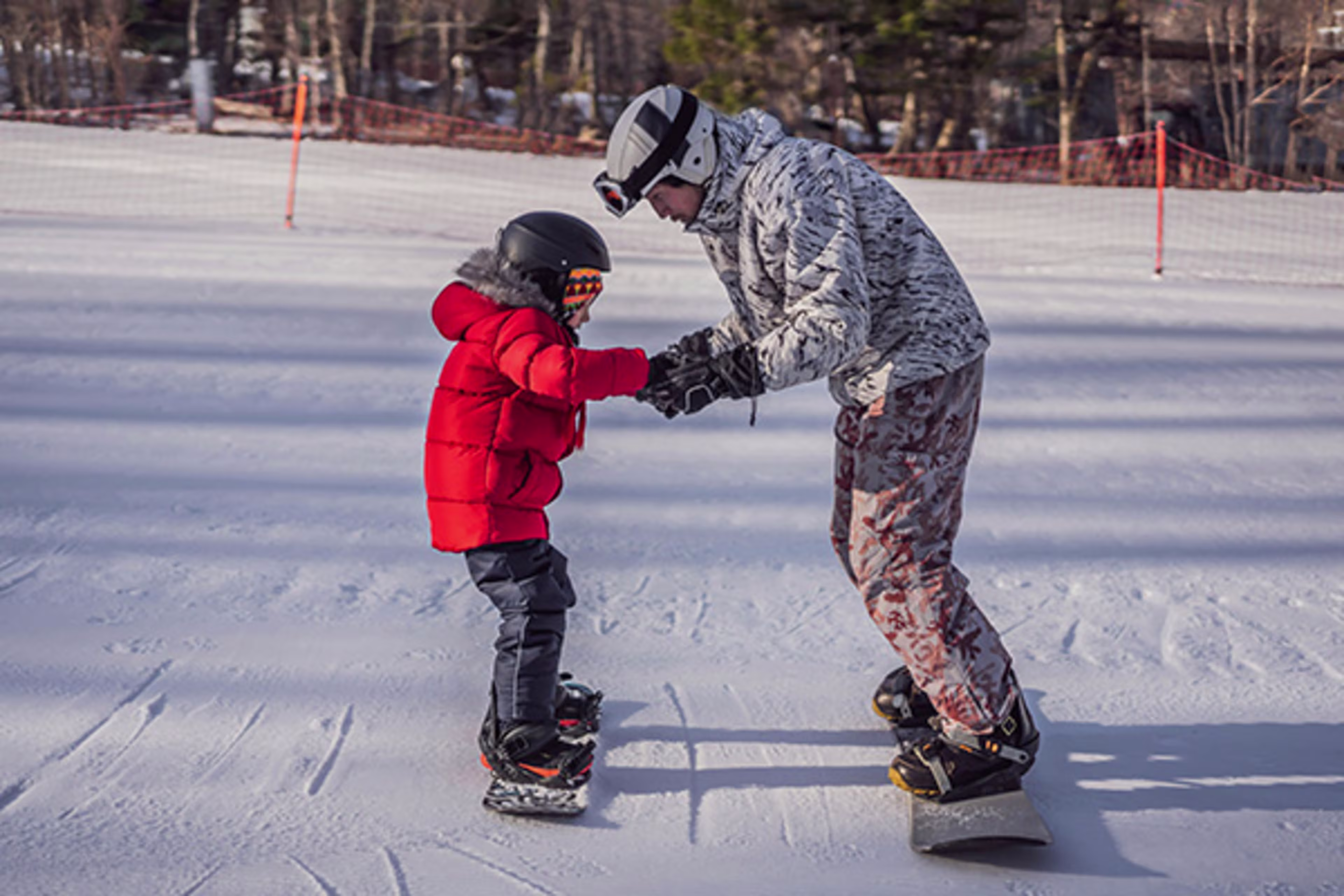 Father teaching his son to snowboard in the Colorado mountains, with overlay text 'Adjustable Rate Mortgage'—Westerra helps families grow with flexible home financing options.