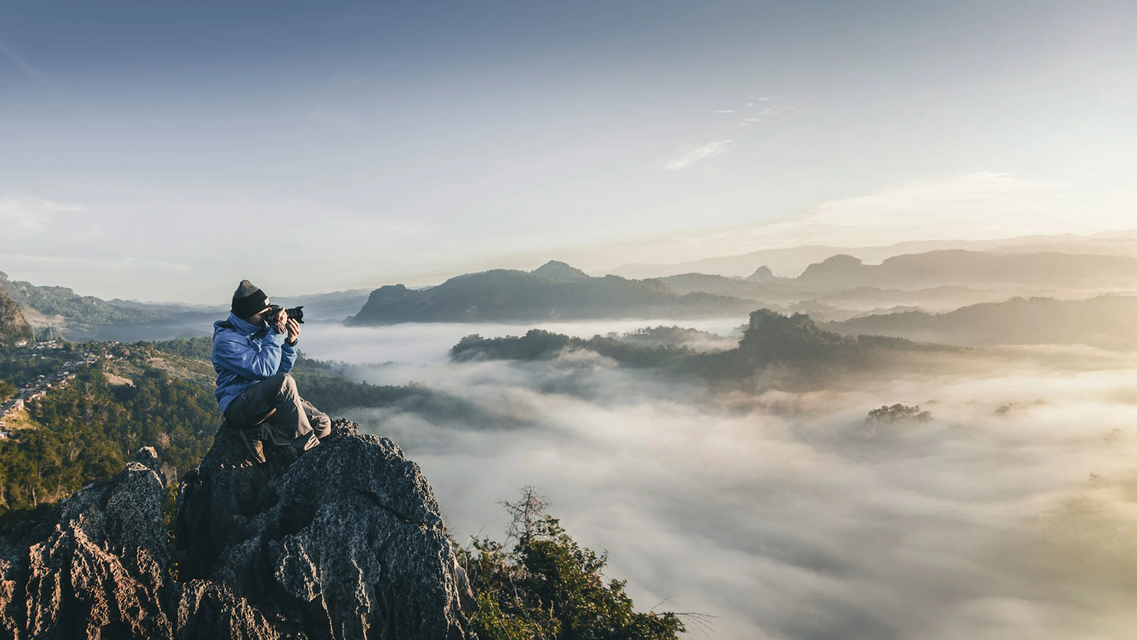 Small Business Owner taking photos of Colorado Mountains, with Westerra's small business solutions to watch their business grow.