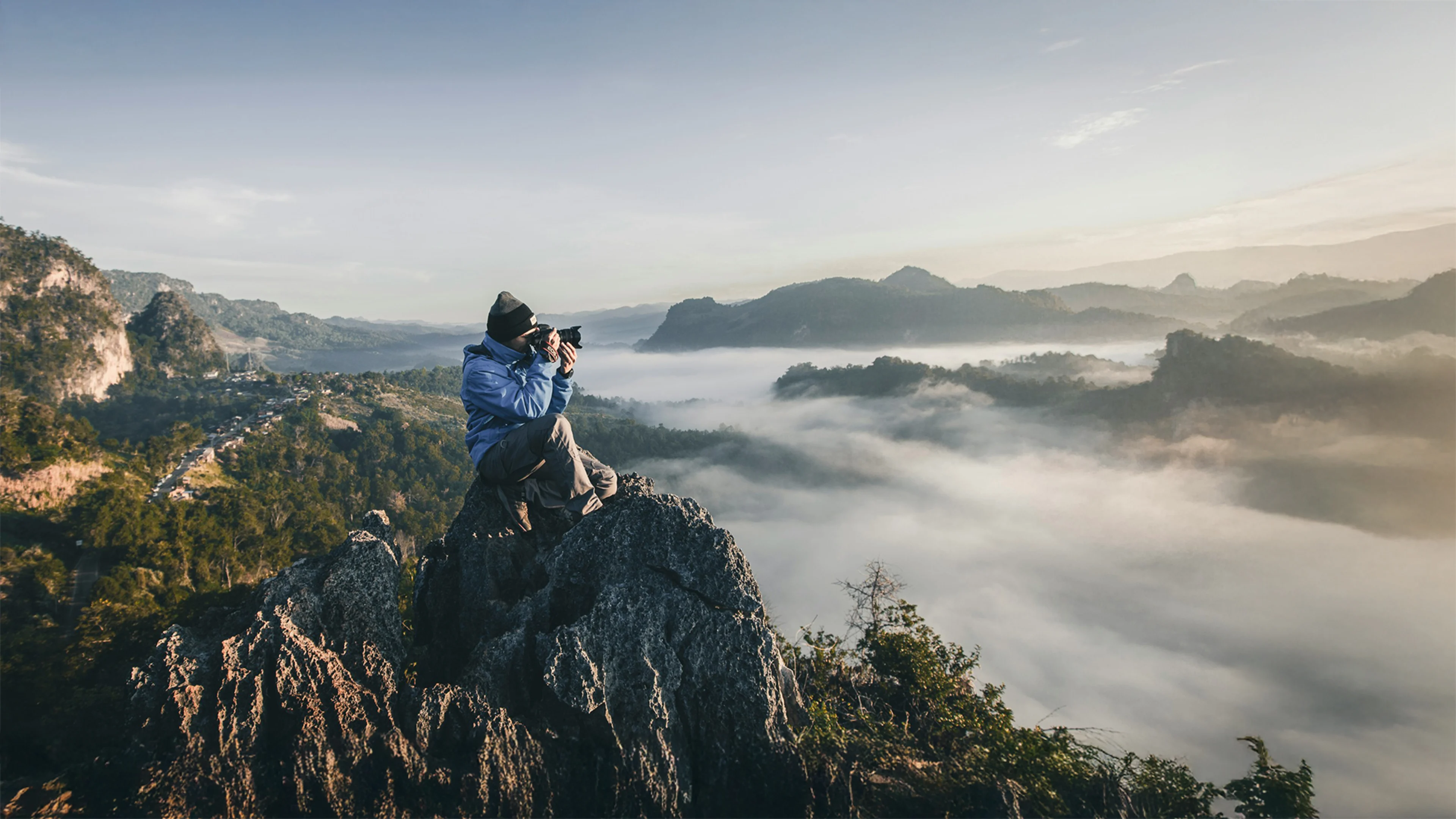 Small Business Owner taking photos of Colorado Mountains, with Westerra's small business solutions to watch their business grow.