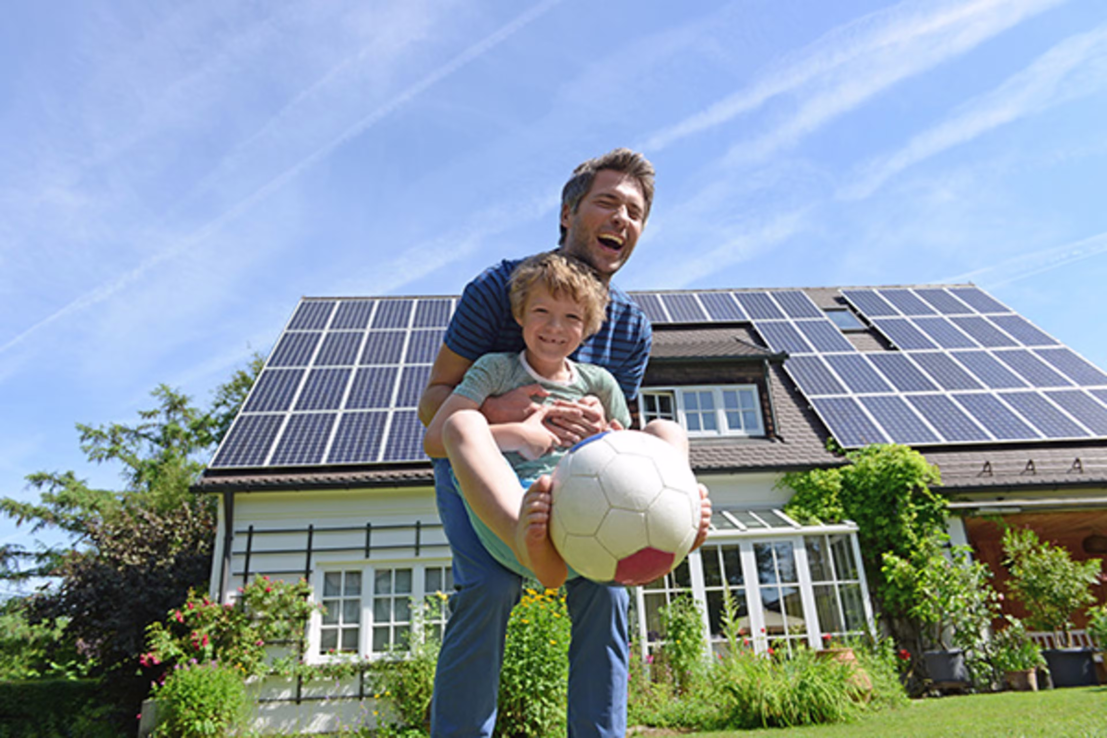 Father and son enjoying their energy efficient home, with a Westerra RENU Loan.
