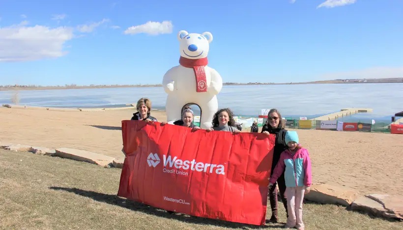 Polar Plunge participants holding a Westerra banner