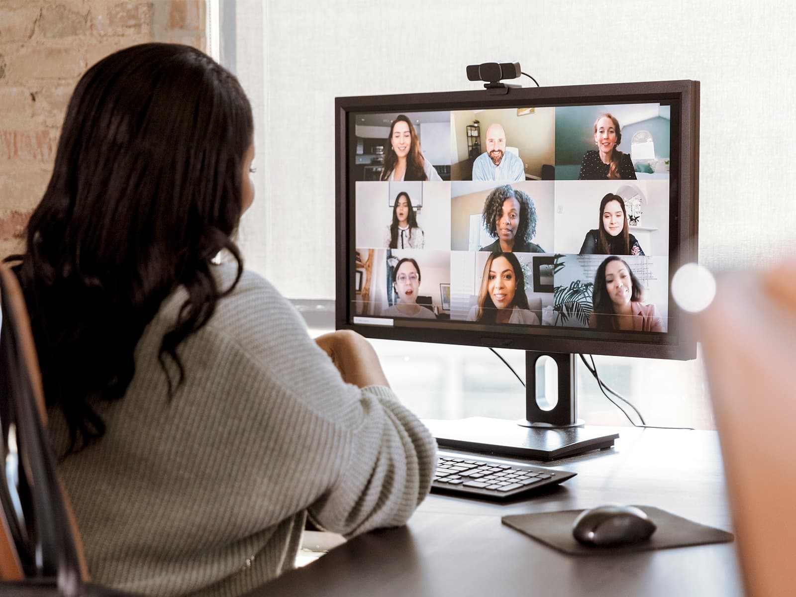 Woman on a virtual call with 8 others