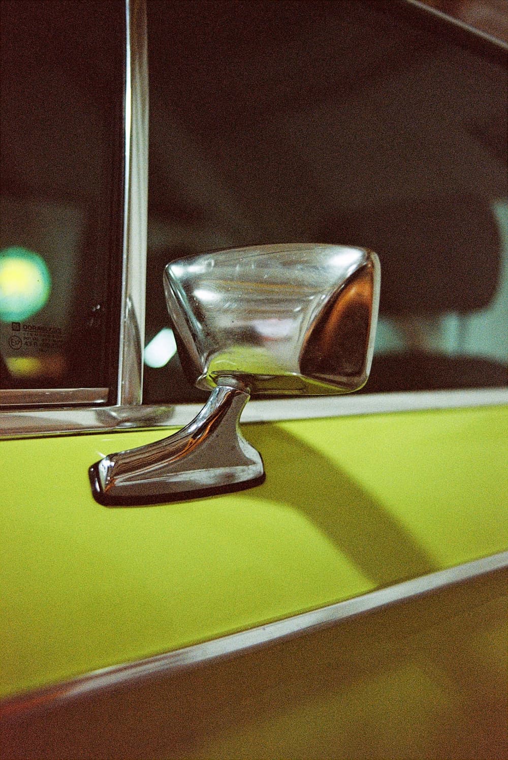 Close-up of a green auto with overlay text 'Members Who Saved with Us by Refinancing Their Auto Loan,' highlighting savings through refinancing with a credit union near me. 