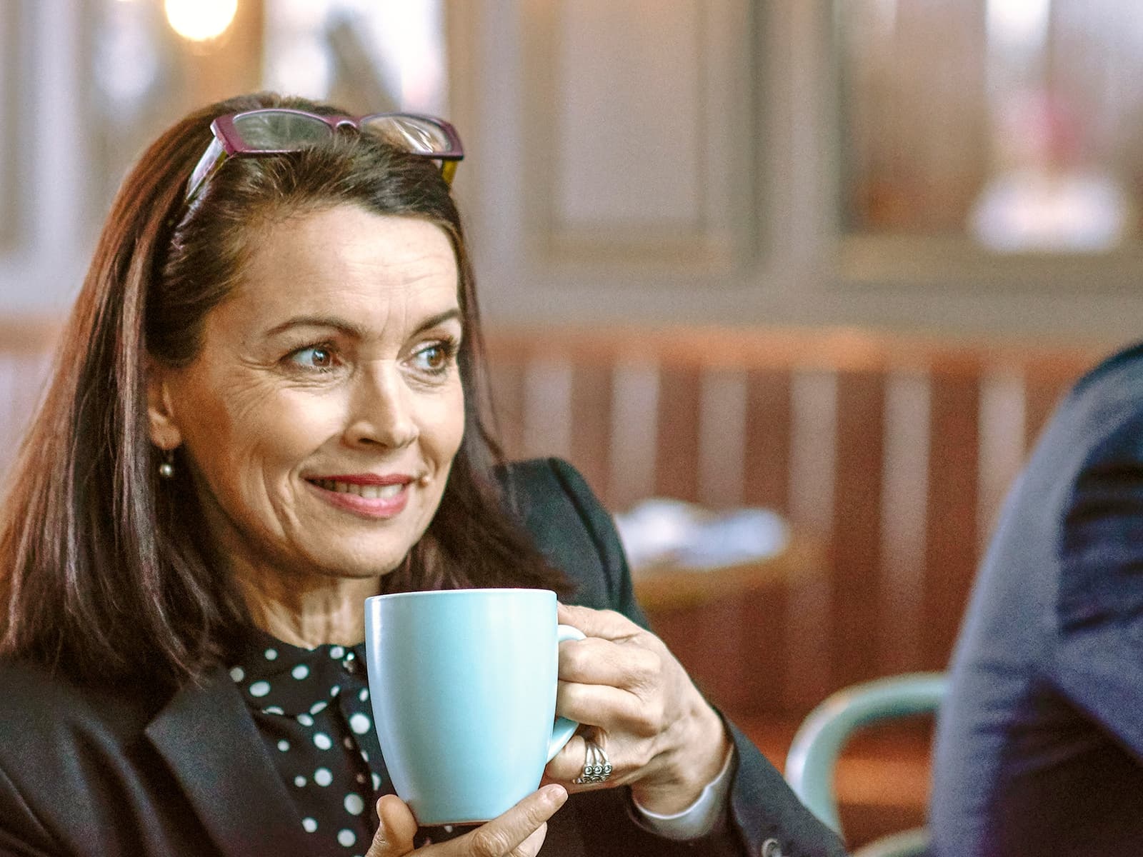 Woman drinking out of a mug