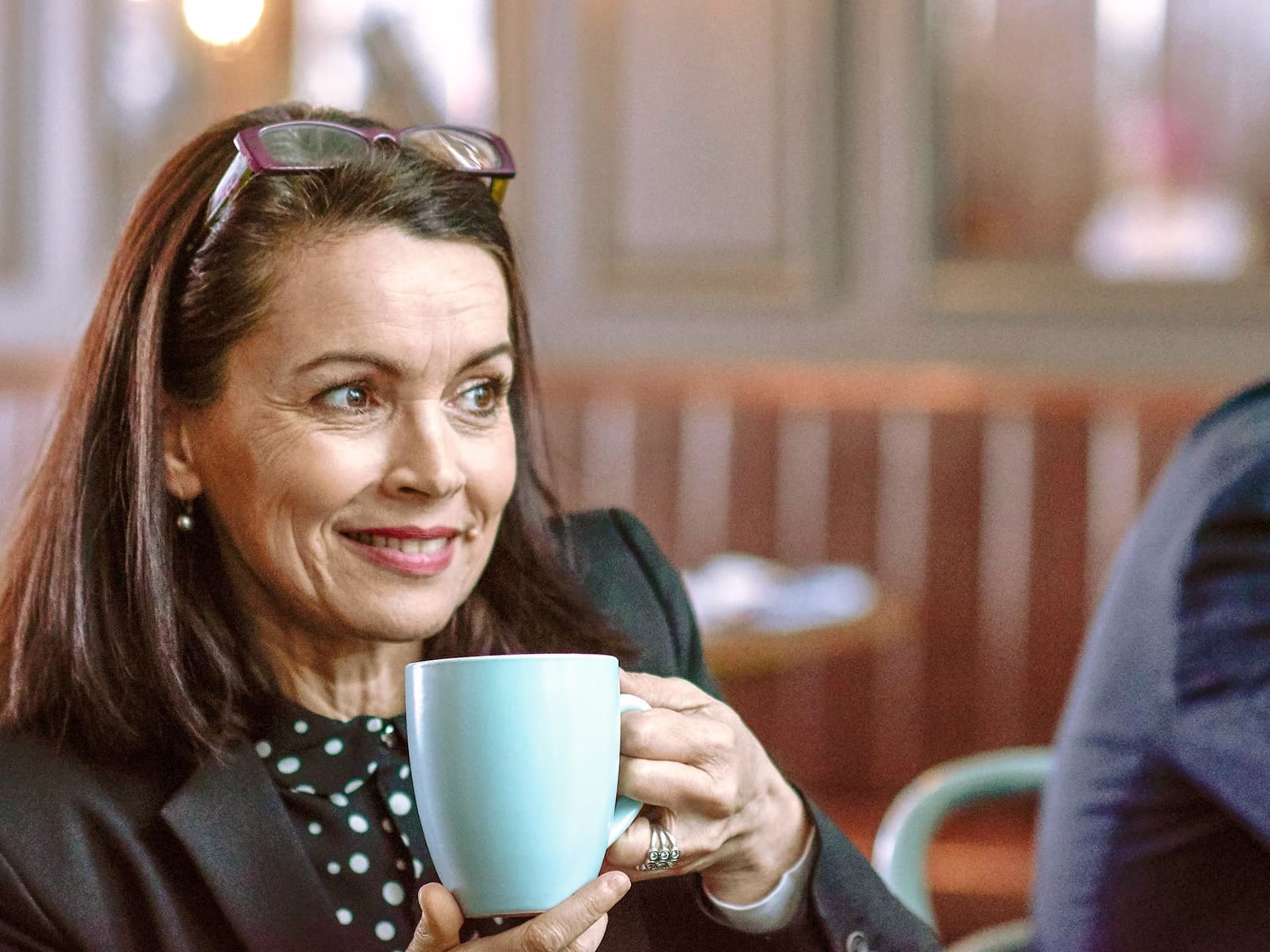 Woman drinking out of a mug