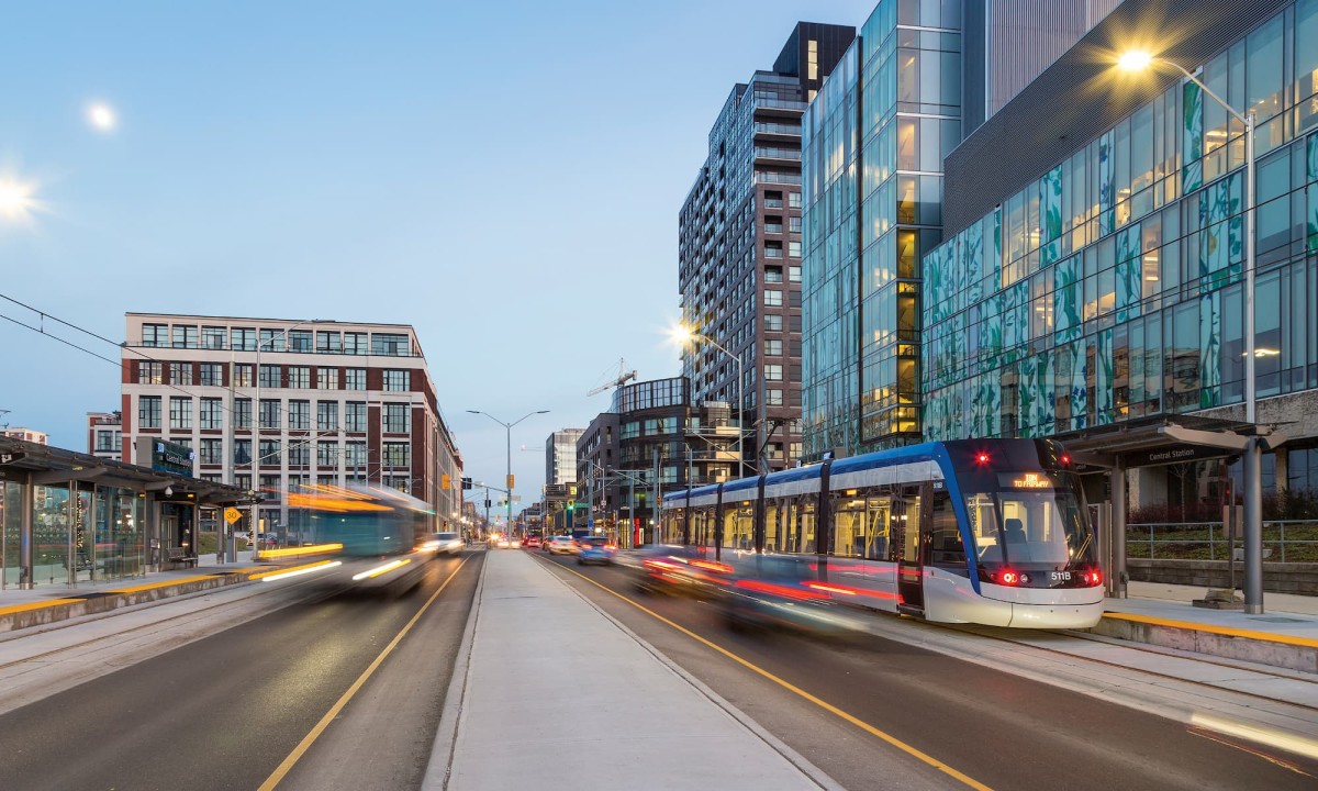 View of traffic down King Street in Kitchener featuring the ION train