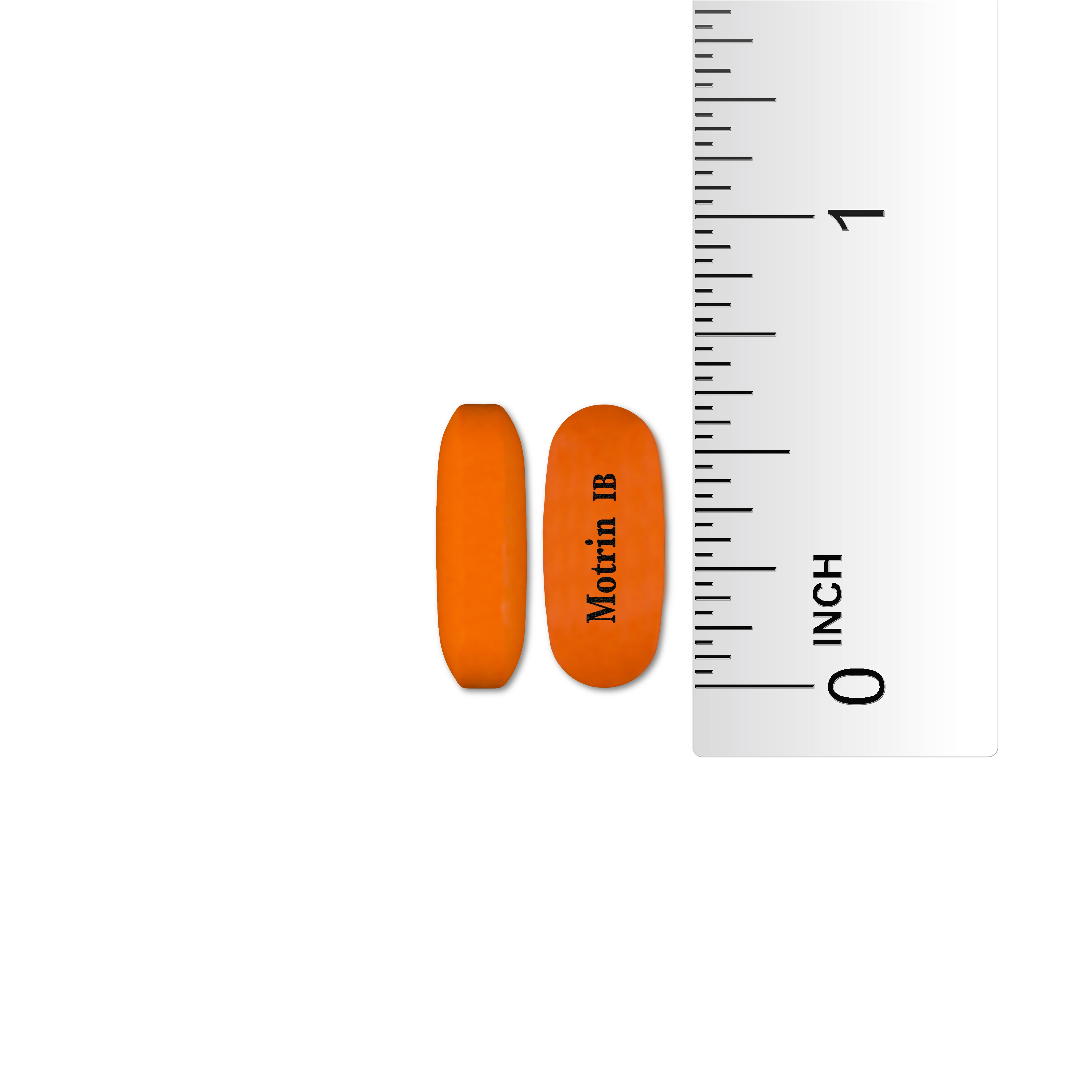 Two orange Motrin IB tablets next to a ruler showing their size. The tablets are approximately Â¾ inch long.