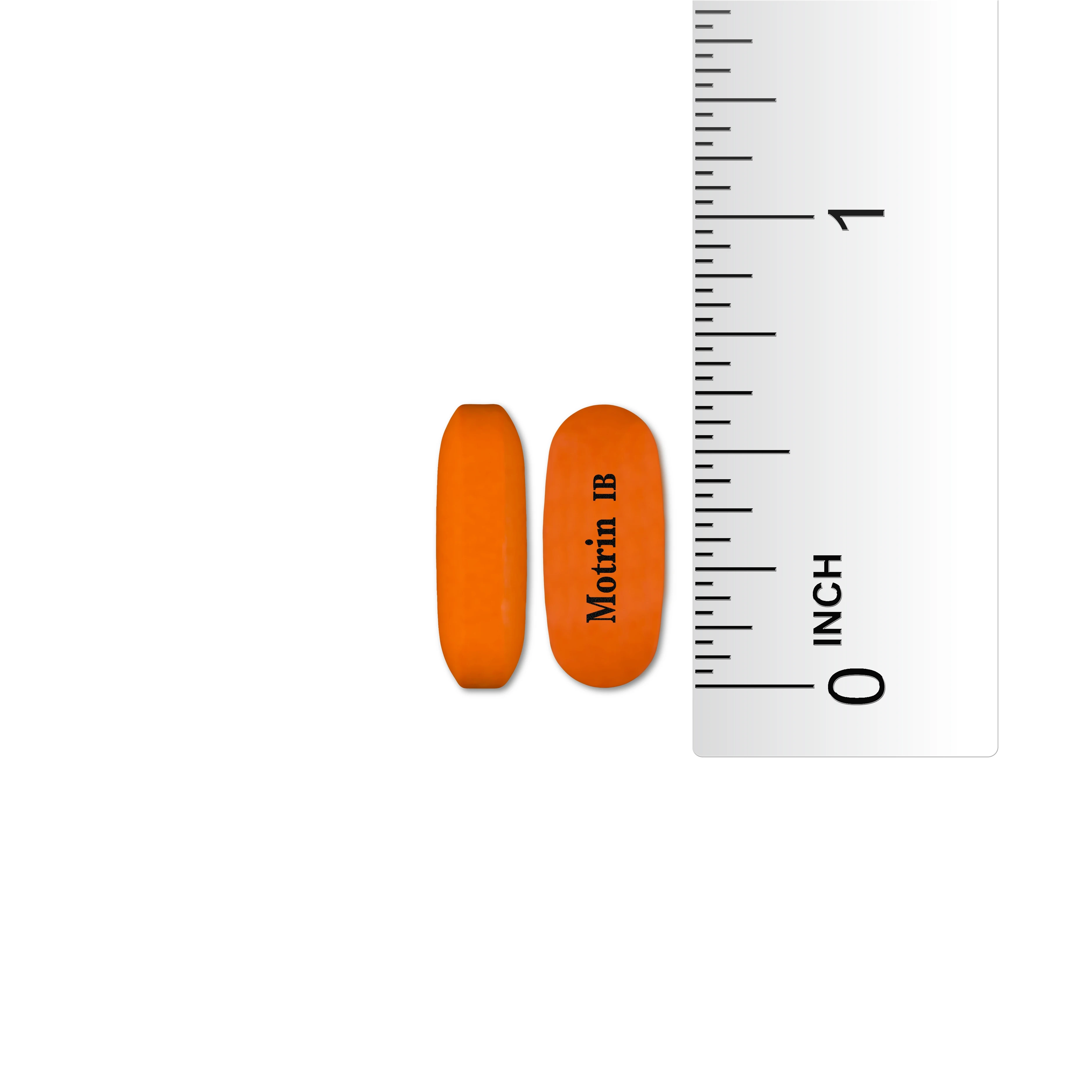 Two orange Motrin IB tablets next to a ruler showing their size. The tablets are approximately Â¾ inch long.