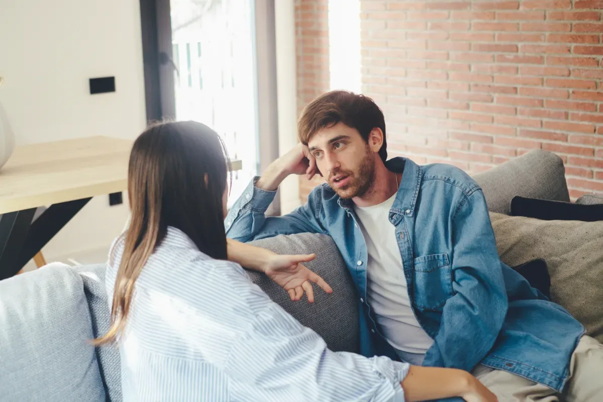 In gesprek met je naasten - man en vrouw in serieus gesprek op bankstel