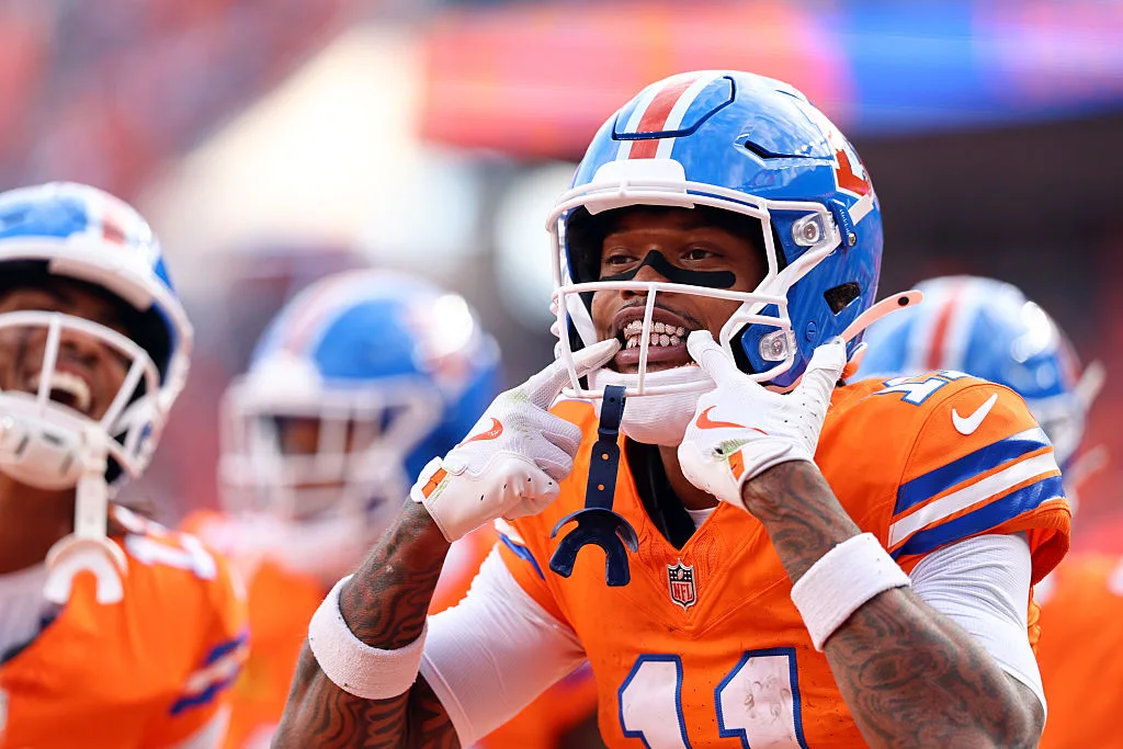 Denver Broncos wide receiver Troy Franklin points to his smile during a game.