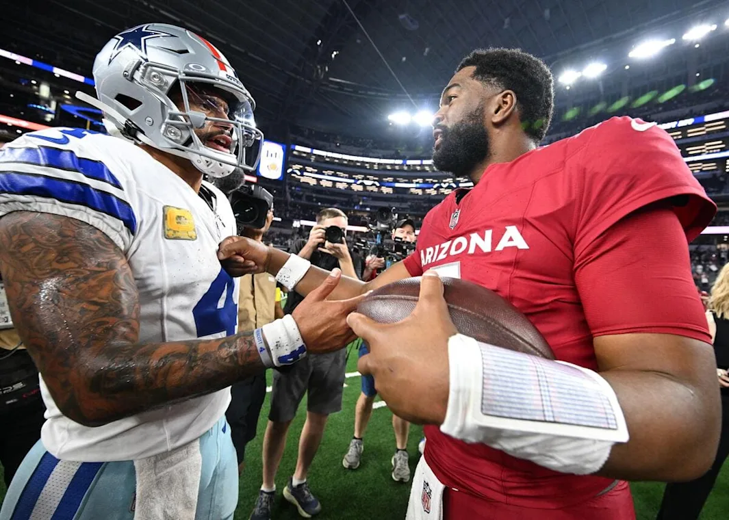 Dallas Cowboys quarterback Dak Prescott tallks to Arizona Cardinals quarterback Jacoby Brissett after a game.