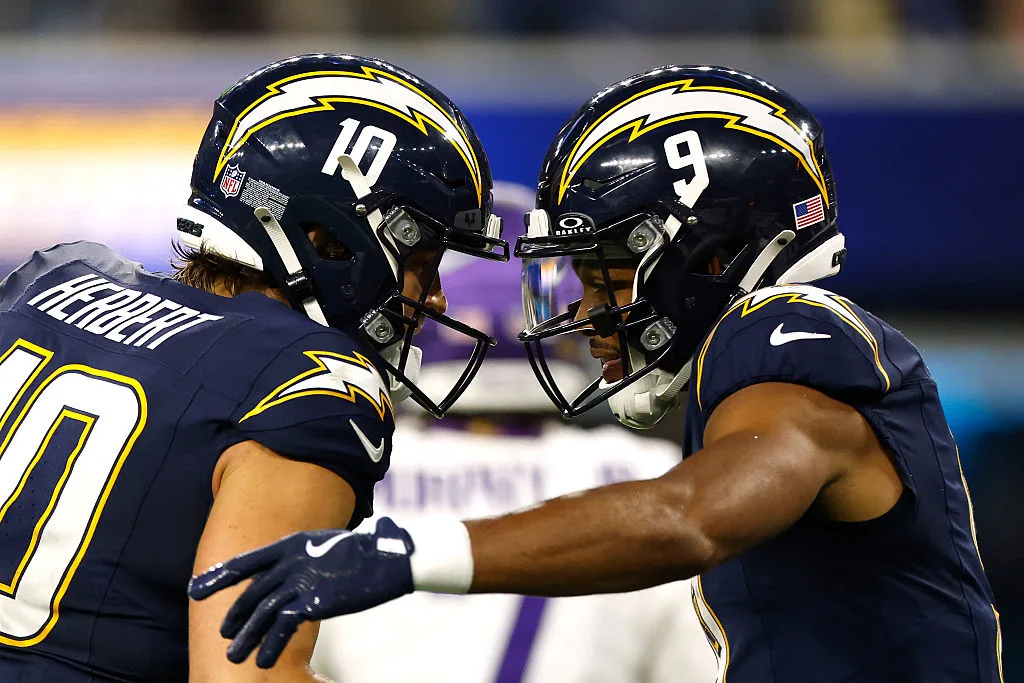 Los Angeles Chargers quarterback Justin Herbert and wide receiver Tre Harris butting heads in celebration.