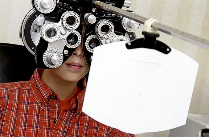 boy getting an eye exam with high myopia