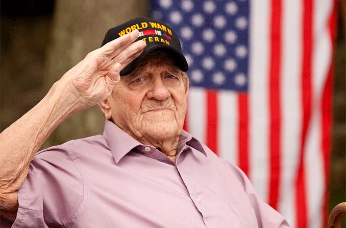 Veteran with low vision saluting with American flag in background