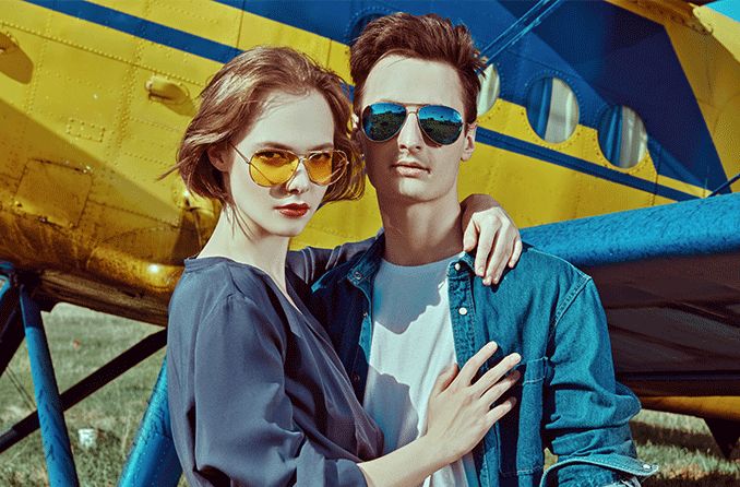 man and woman wearing aviator glasses