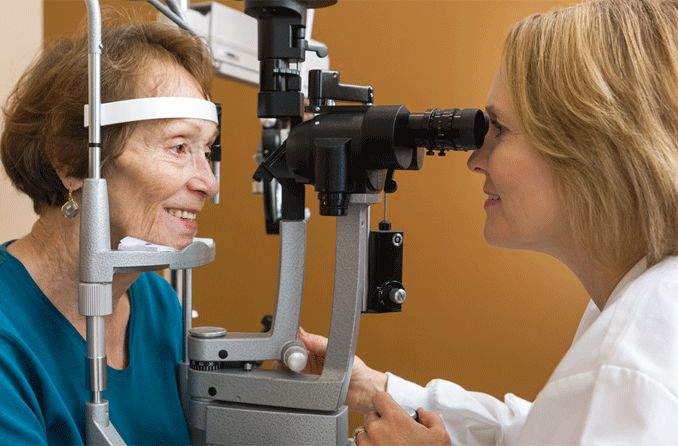 senior woman receiving eye exam