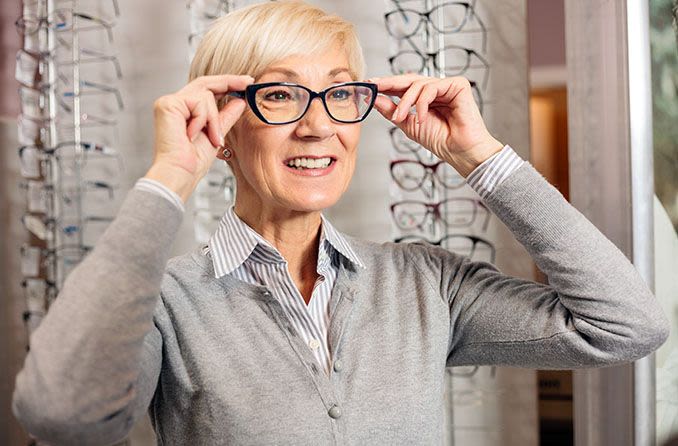 Mature woman trying on eyeglasses