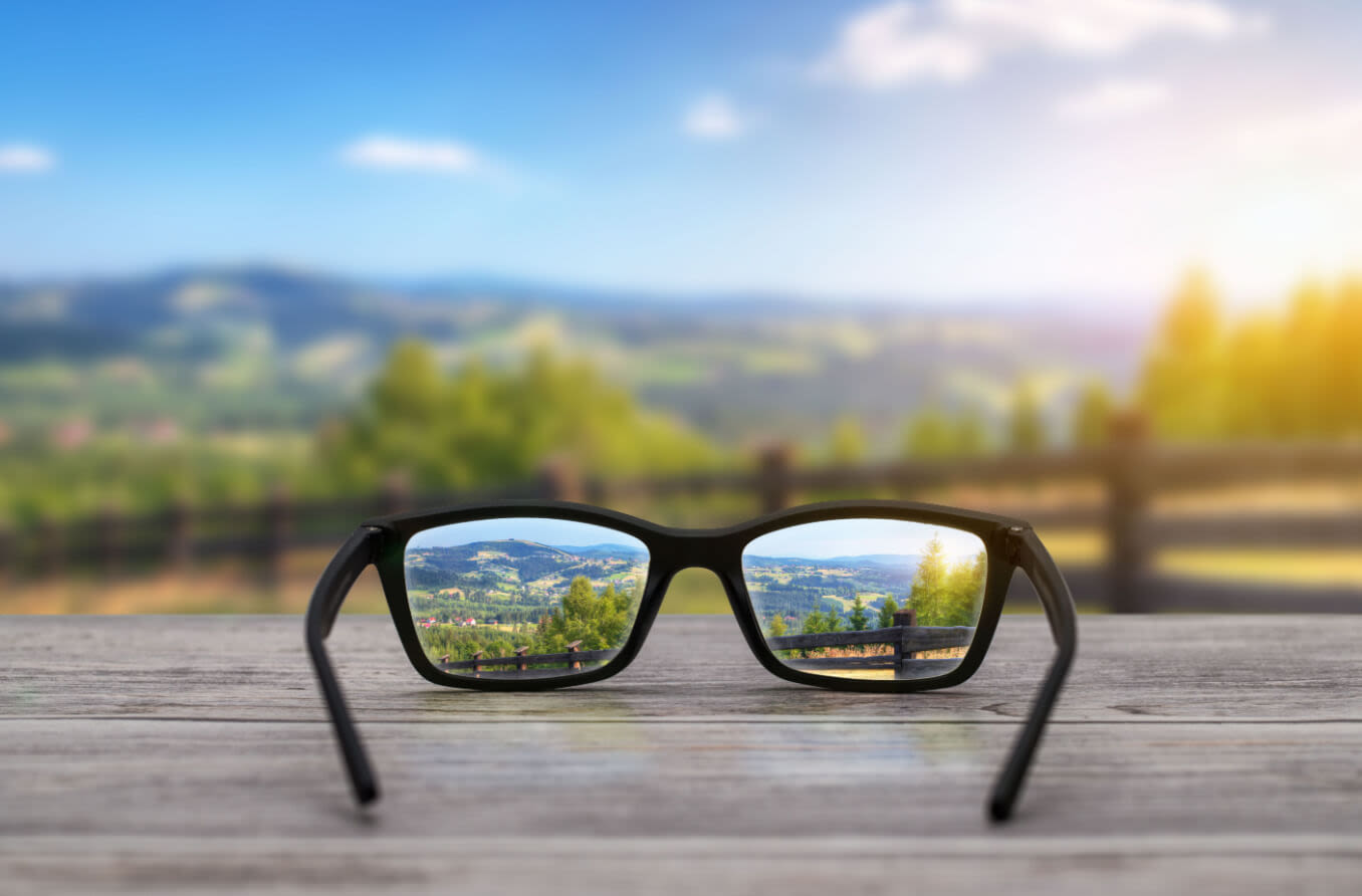 glasses focused on scenic background