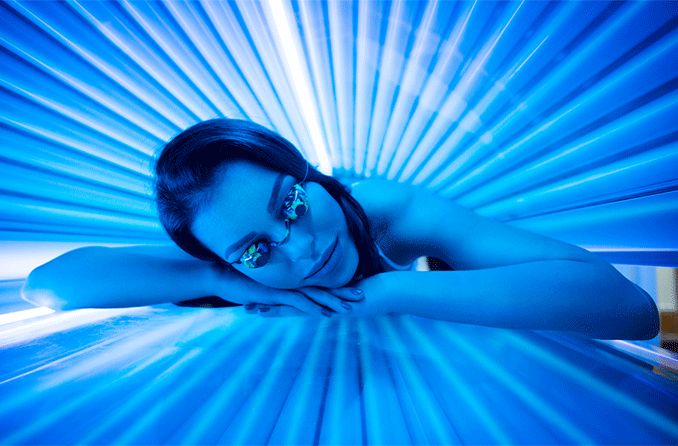 woman in tanning bed with uv light
