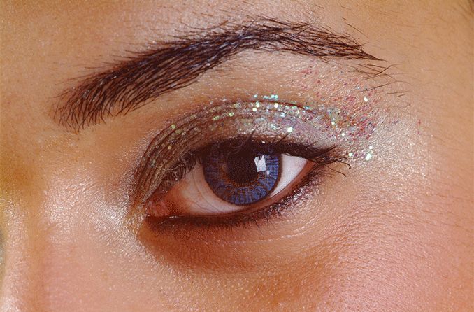 closeup of woman's eye with glitter makeup