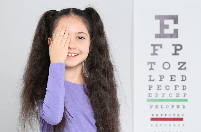 young girl taking an eye test