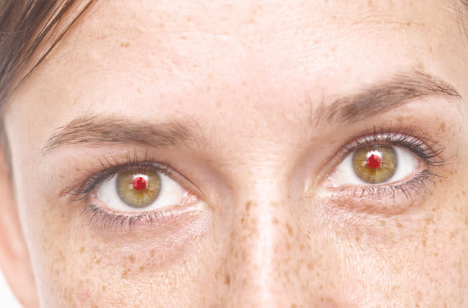 Close-up of woman with red eyes in a photo