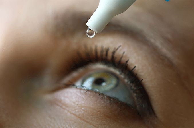 closeup of an eye getting treated with lumify eye drops