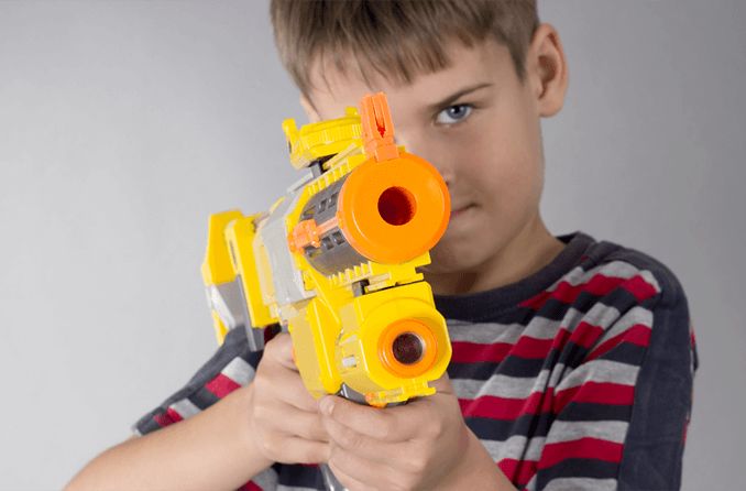 boy with toy dart gun not safe for the eyes