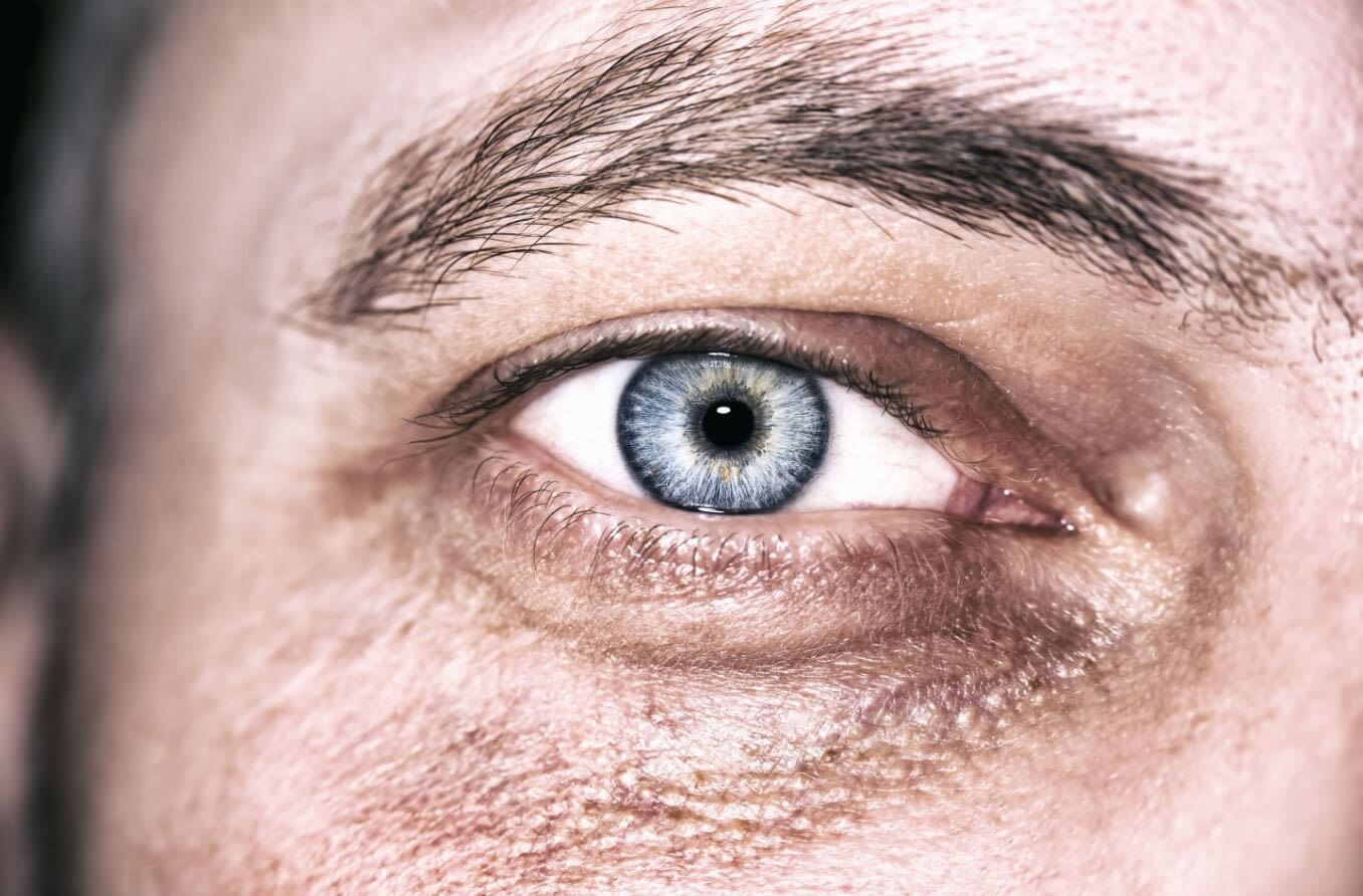 Closeup of man with light blue eyes.