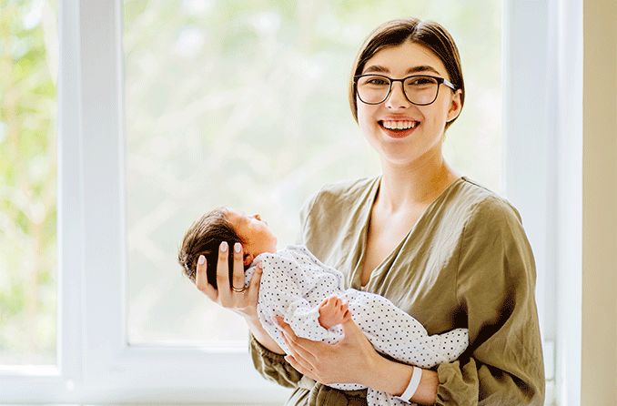 woman with myopia holding her baby