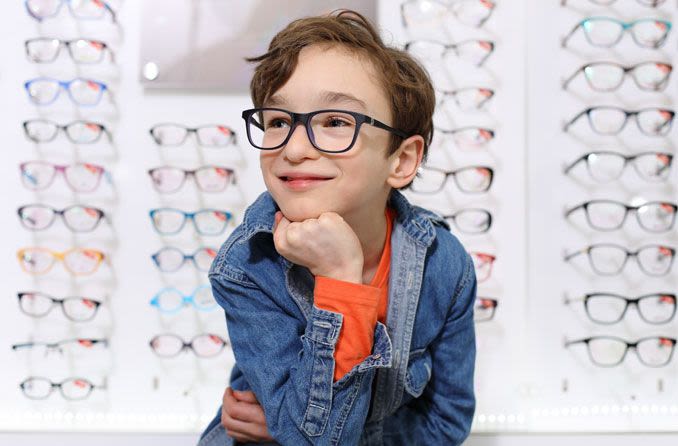 Happy boy posing in his new glasses