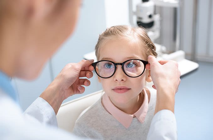 young girl getting new pair of prescription eyeglasses