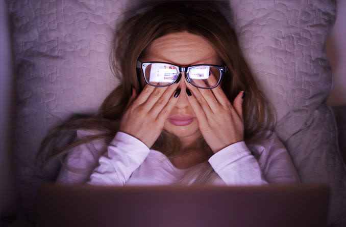 Woman rubbing eyes from prolonged computer usage