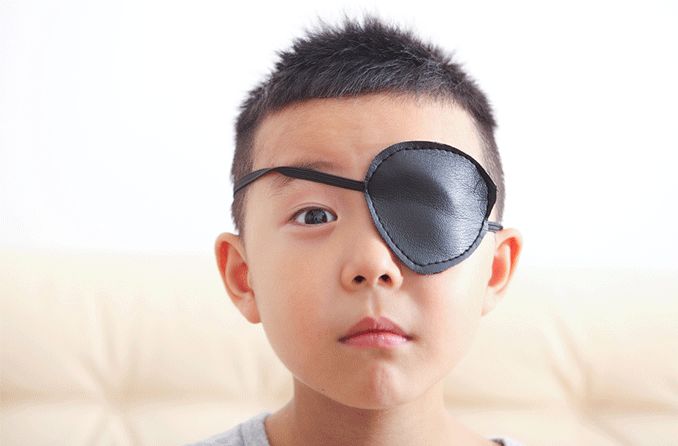 boy wearing eye patch